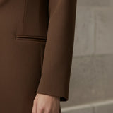 mocha blazer worn by a person against a neutral background