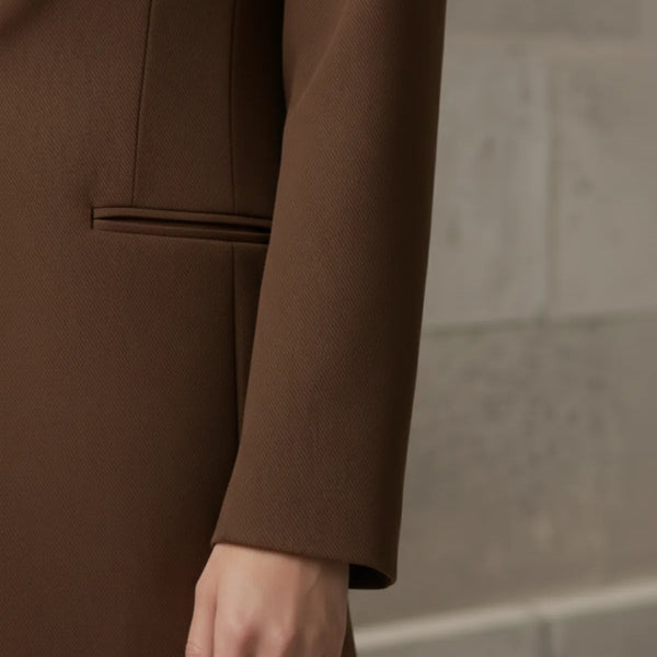 mocha blazer worn by a person against a neutral background