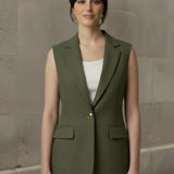 Front view of a woman modeling an olive green tailored sleeveless blazer fastened with a single gold button, featuring classic lapels and flap pockets.