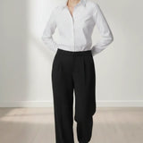 Person wearing a white shirt and black trouser against a white background