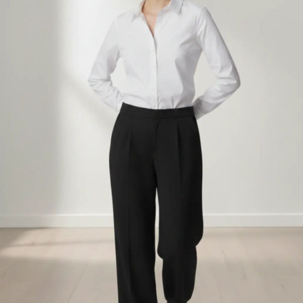 Person wearing a white shirt and black trouser against a white background