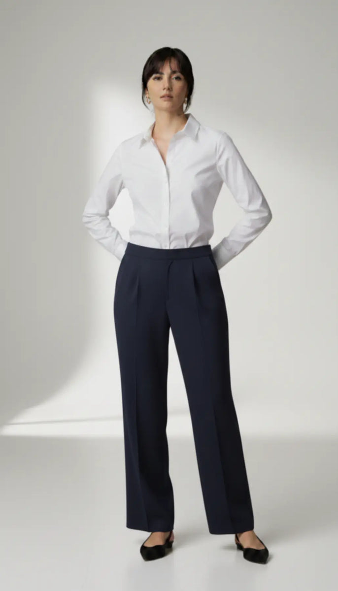 Person wearing a white shirt and navy trouser on a white background