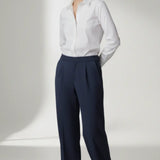 Person wearing a white shirt and navy pants on a white background