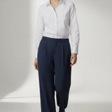 Person wearing a white shirt and navy pants on a white background