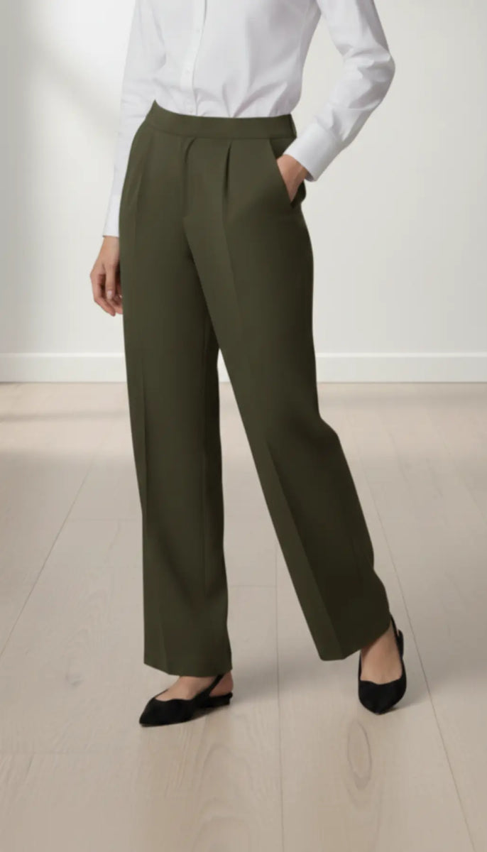 Person wearing olive pants and a white shirt on a light background