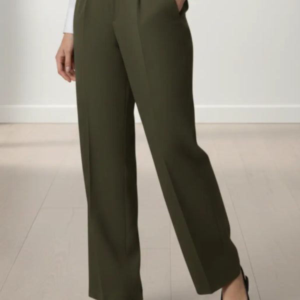 Person wearing olive pants and a white shirt on a light background