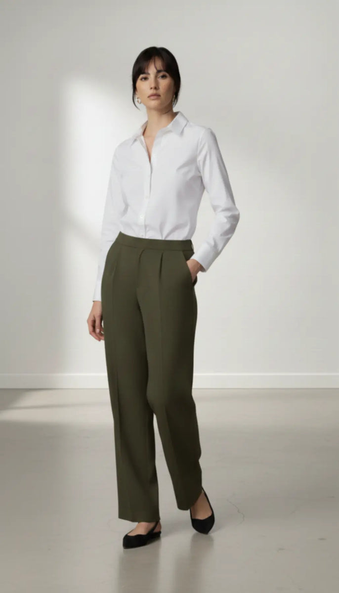 Person wearing a white shirt and olive pants against a white background