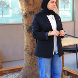 “ZAYTA black women’s blazer on model with white shirt and blue jeans, standing near a tree”
