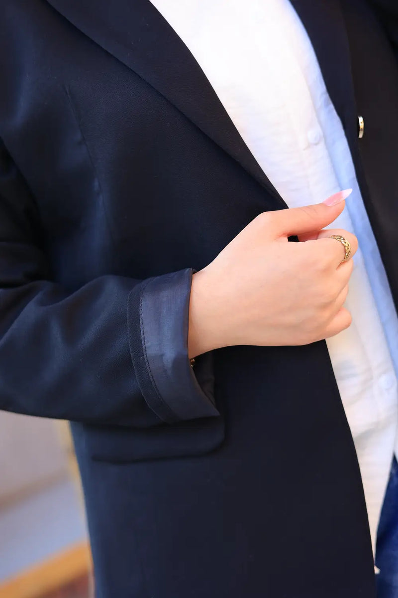 “ZAYTA black tailored blazer on model with white shirt, showing fabric and inner lining, holding a phone”
