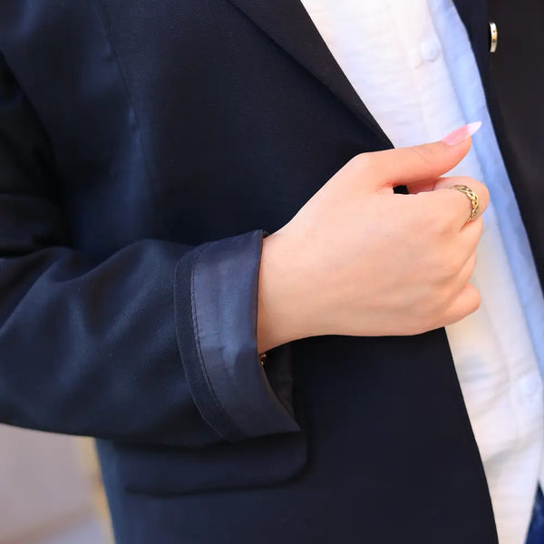 “ZAYTA black tailored blazer on model with white shirt, showing fabric and inner lining, holding a phone”
