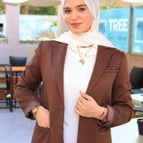 ZAYTA brown tailored blazer on model over white shirt, showing fabric and inner lining, outdoor setting

