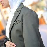 ZAYTA Olive tailored blazer on model with a softly blurred background, highlighting clean fit and premium fabric texture