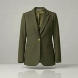 olive blazer with a gold button on a light gray background