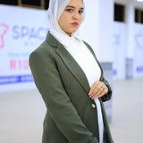 ZAYTA olive tailored blazer on model wearing white hijab, showing fabric and inner lining, indoor setting
