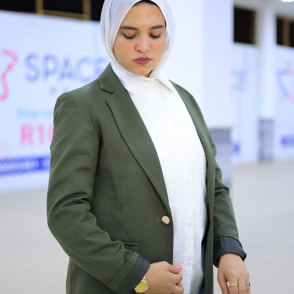 ZAYTA Olive tailored blazer on model wearing white hijab, showing fabric and inner lining, indoor setting

