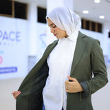 ZAYTA olive tailored blazer on model wearing white hijab, showing fabric and inner lining, indoor setting
