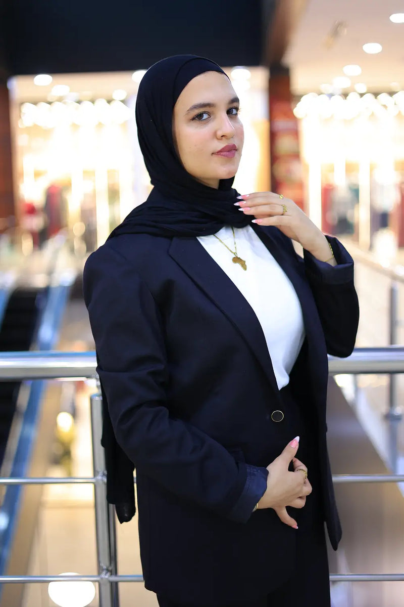“ZAYTA off white women’s blazer on model wearing black hijab, standing in blurred indoor setting”
