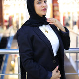 “ZAYTA off white women’s blazer on model wearing black hijab, standing in blurred indoor setting”

