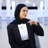 “ZAYTA off white women’s blazer on model wearing black hijab, indoor setting”
