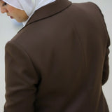 ZAYTA brown tailored blazer on model wearing white hijab, showing fabric and inner lining, indoor setting
