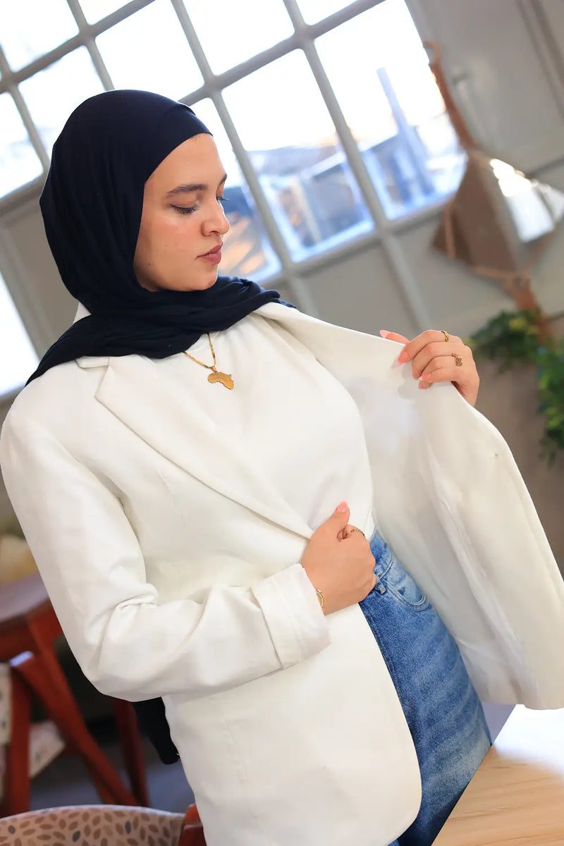 “ZAYTA off white women’s blazer on model wearing black hijab, showing inner lining, indoor setting”