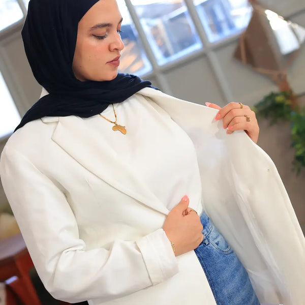 “ZAYTA off white women’s blazer on model wearing black hijab, showing inner lining, indoor setting”