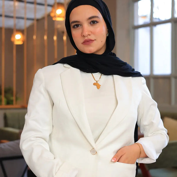 “ZAYTA off white tailored blazer on model wearing black hijab, close-up of fabric and lining, indoor setting”