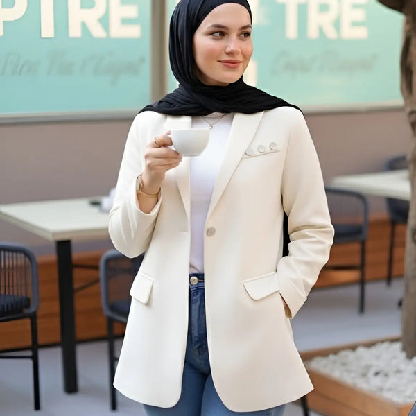 ZAYTA Of-White tailored blazer on model wearing black hijab, showing fabric and inner lining, holding a phone in casual setting