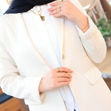 ZAYTA Off-white tailored coat on model, showing fabric and inner lining, with blurred background